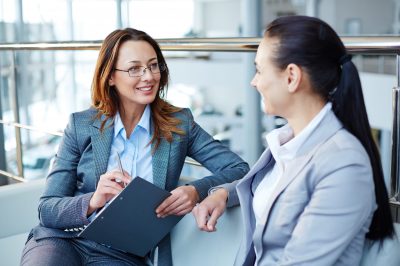 Two business partners sitting and communicating with each other